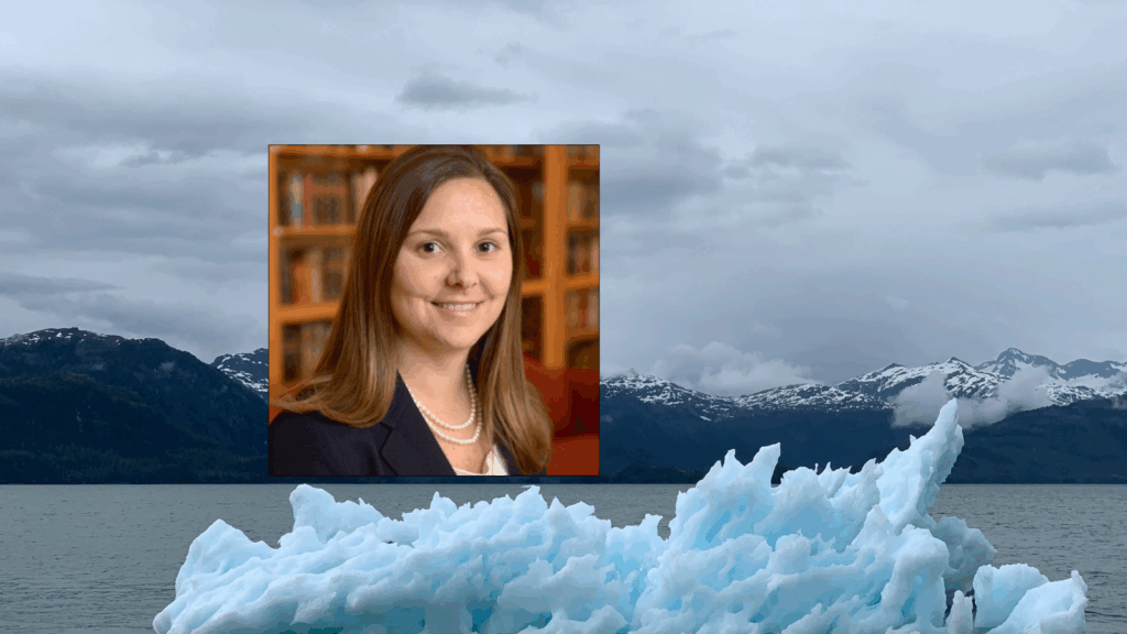 A woman with long brown hair in a dark suit and double strand of pearls superimposed over an image of melting icebergs.