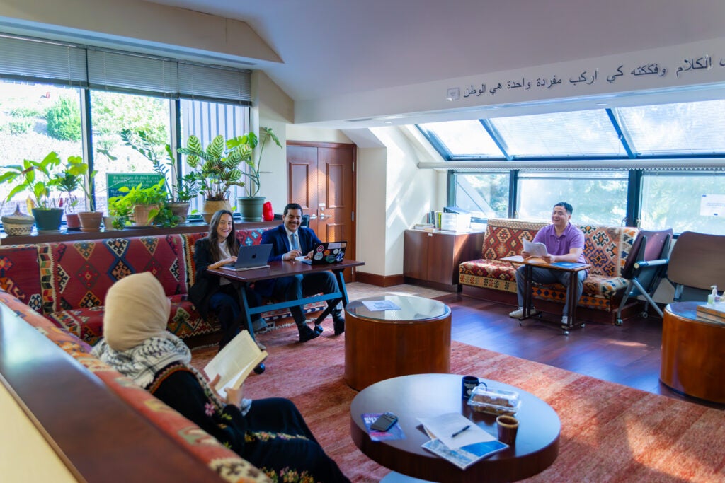 Four people sit in the CCAS lounge.