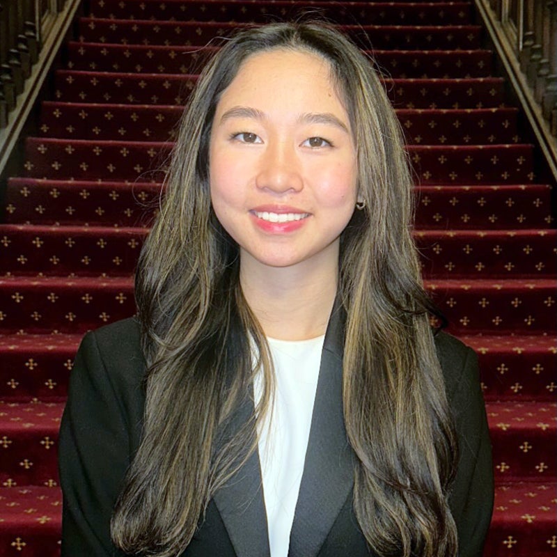 Headshot of Anita TUN smiling, wearing business formal ware