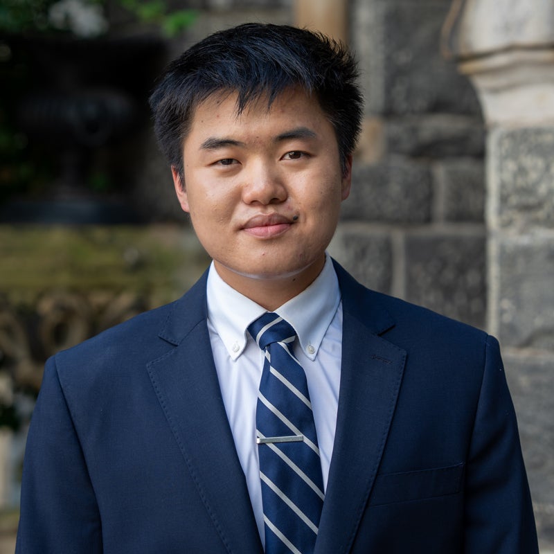 Headshot of Ben LEONG smiling wearing a suit