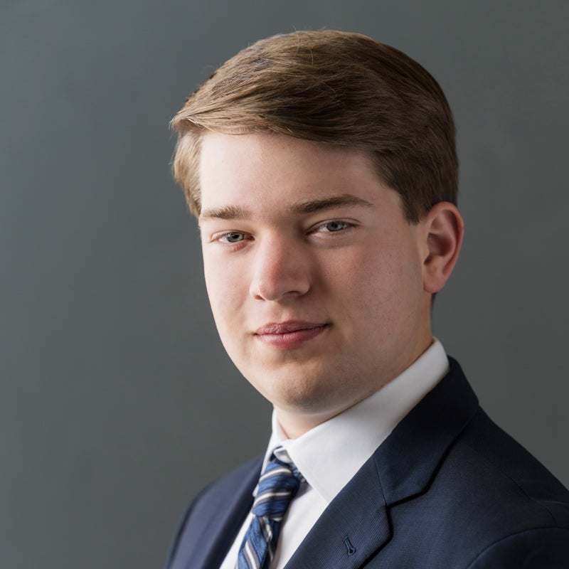 Headshot of Luke MADDEN wearing a suit