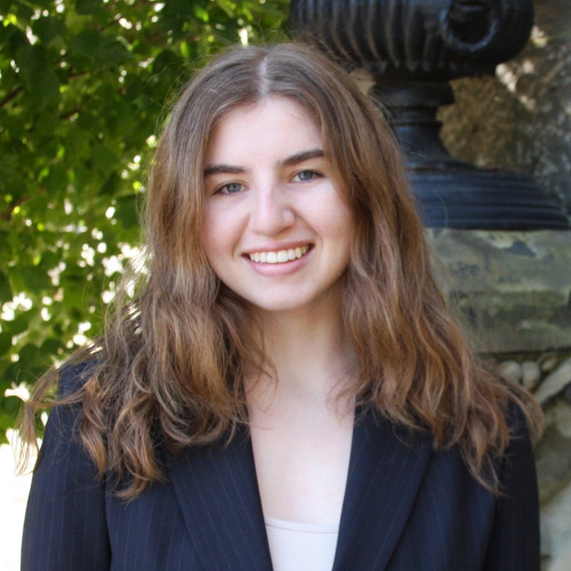 Headshot of Maya BELORUSSKIY smiling, wearing business formal clothing