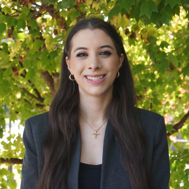 Headshot of Angelina Georgacopoulos smiling wearing business attire