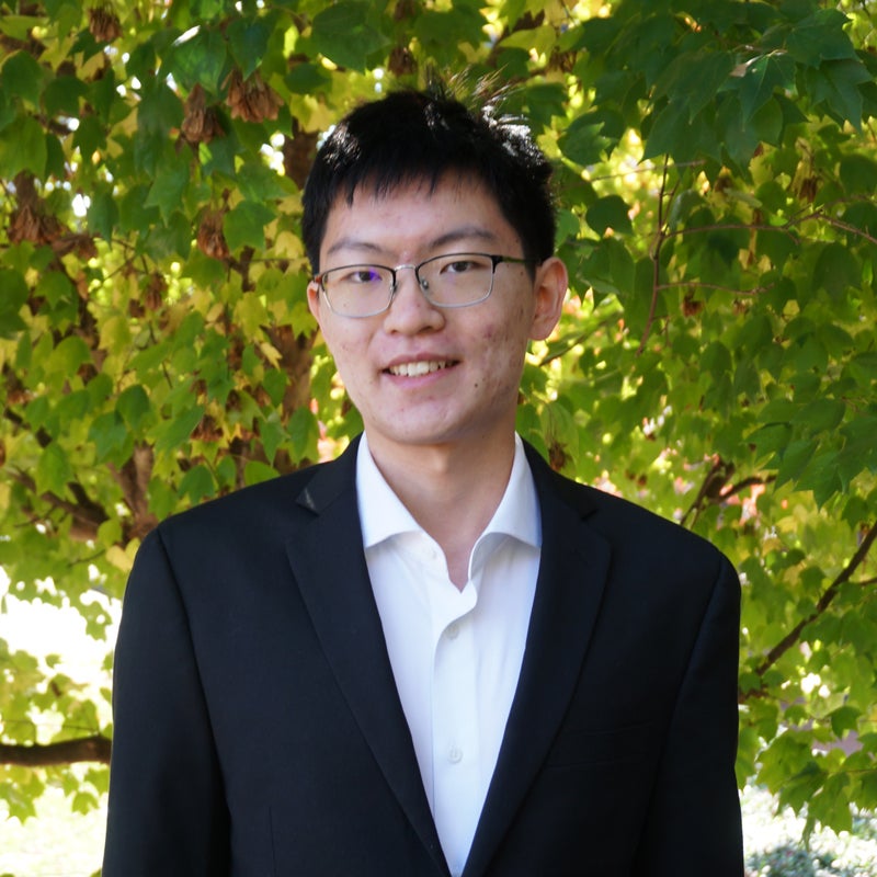 Headshot of Frank Liu smiling wearing business attire