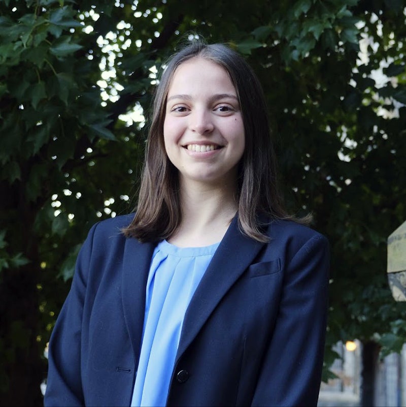 Headshot of Isabel Stein smiling wearing business attire