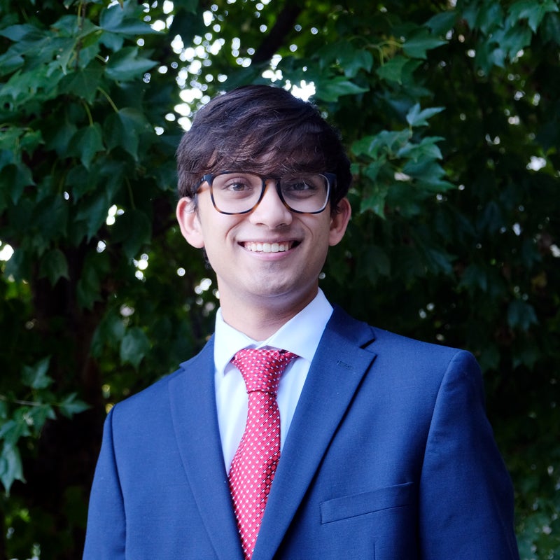 Headshot of Jiyon Chatterjee smiling wearing business attire
