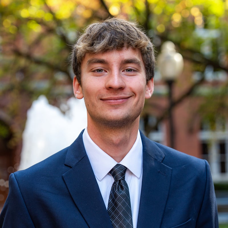 Headshot of Michael Sapozhnikov smiling wearing business attire
