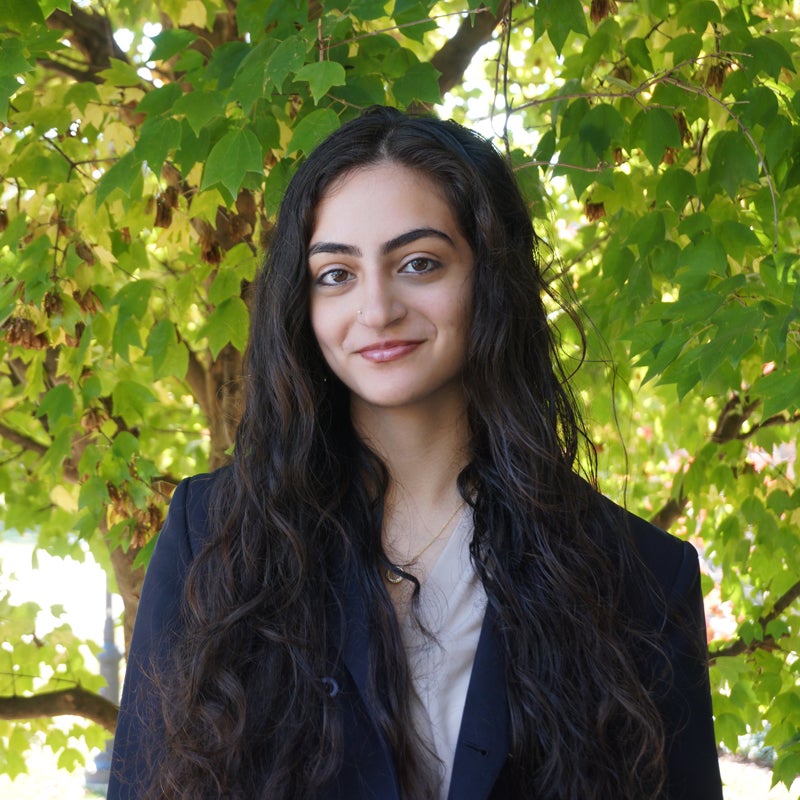 Headshot of Pooja Narayan smiling wearing business attire