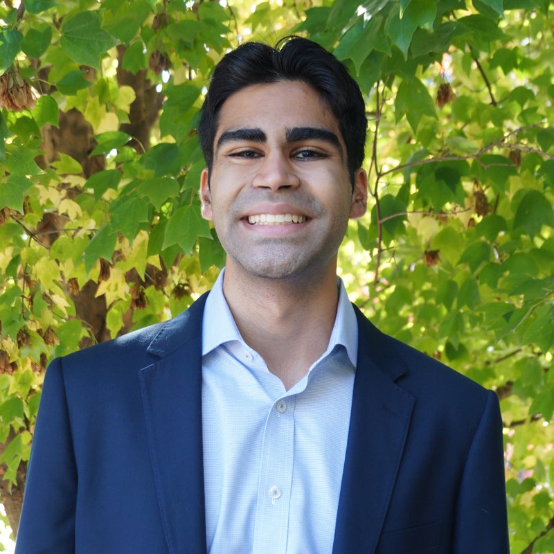 Headshot of Pujan Shah smiling wearing business attire
