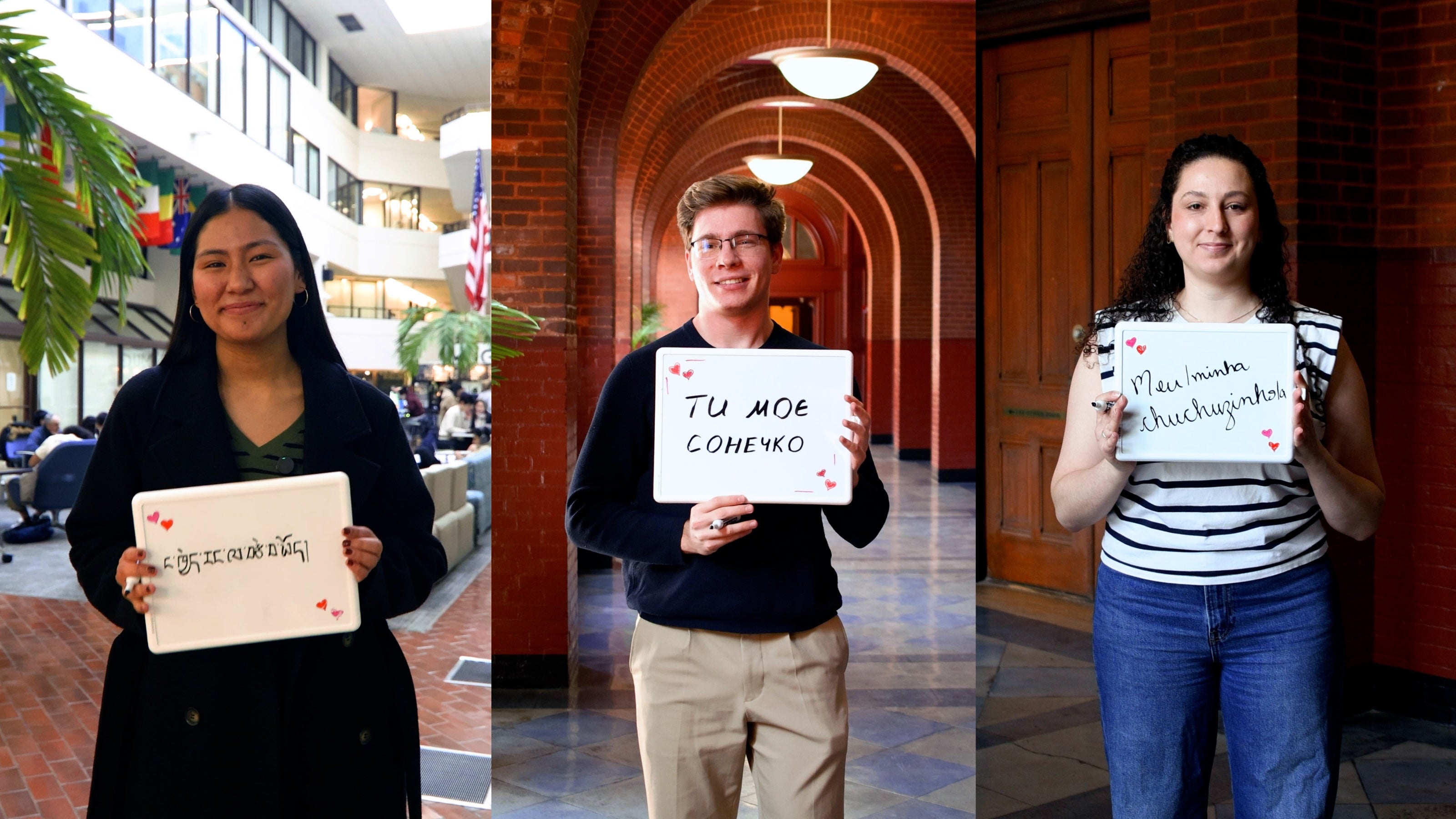 Three individuals, each holding a small white board with writing in foreign languages.