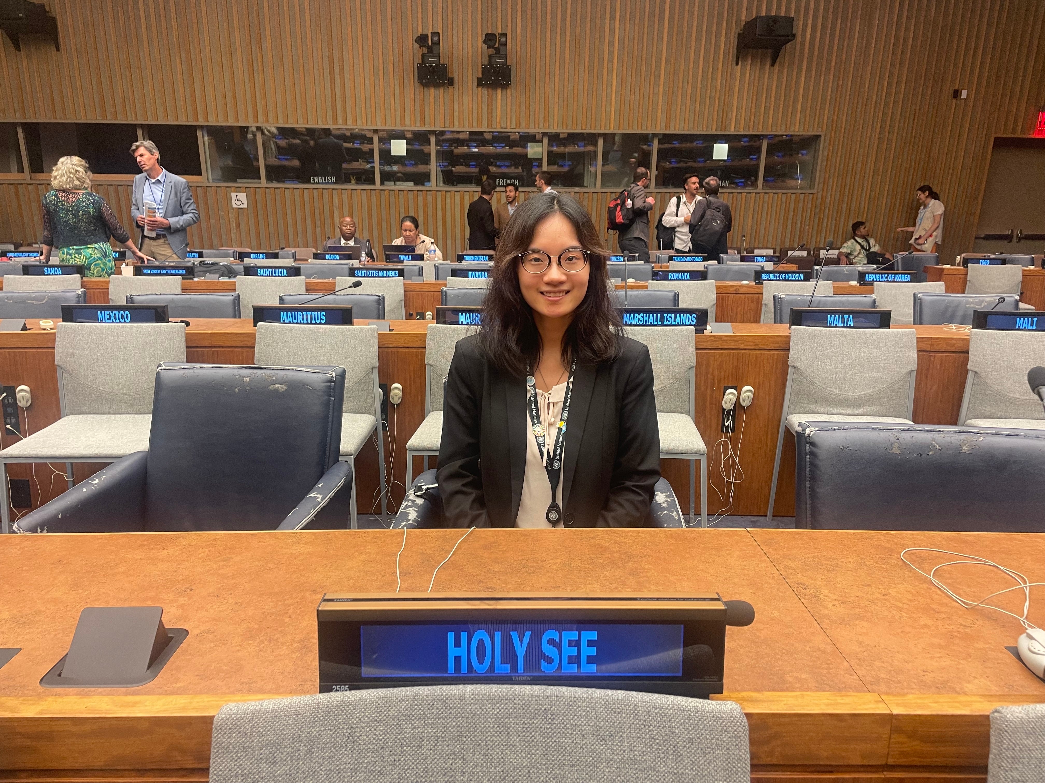 A woman with long dark hair sits behind the Holy See nameplate during the High-Level Political Forum at the United Nations.