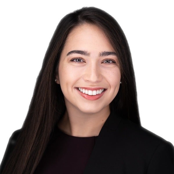 Lindsay Dixon, long dark hair, bright smile, black top, white background