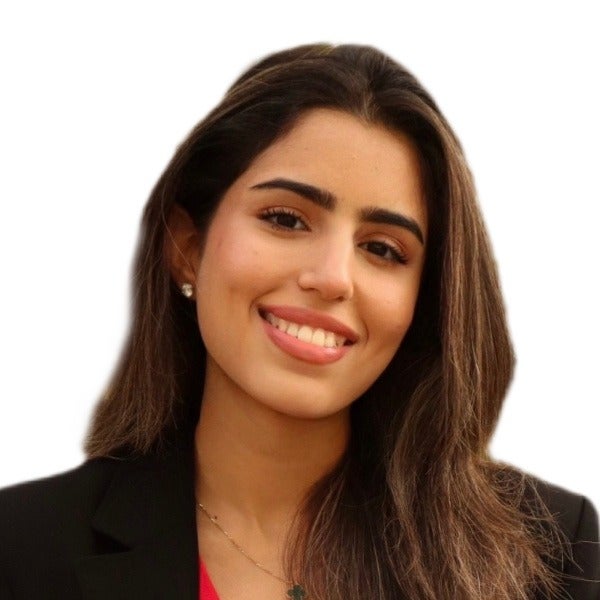 Zaineh Alhameed, long brown hair, warm smile, small earrings, red top with black blazer