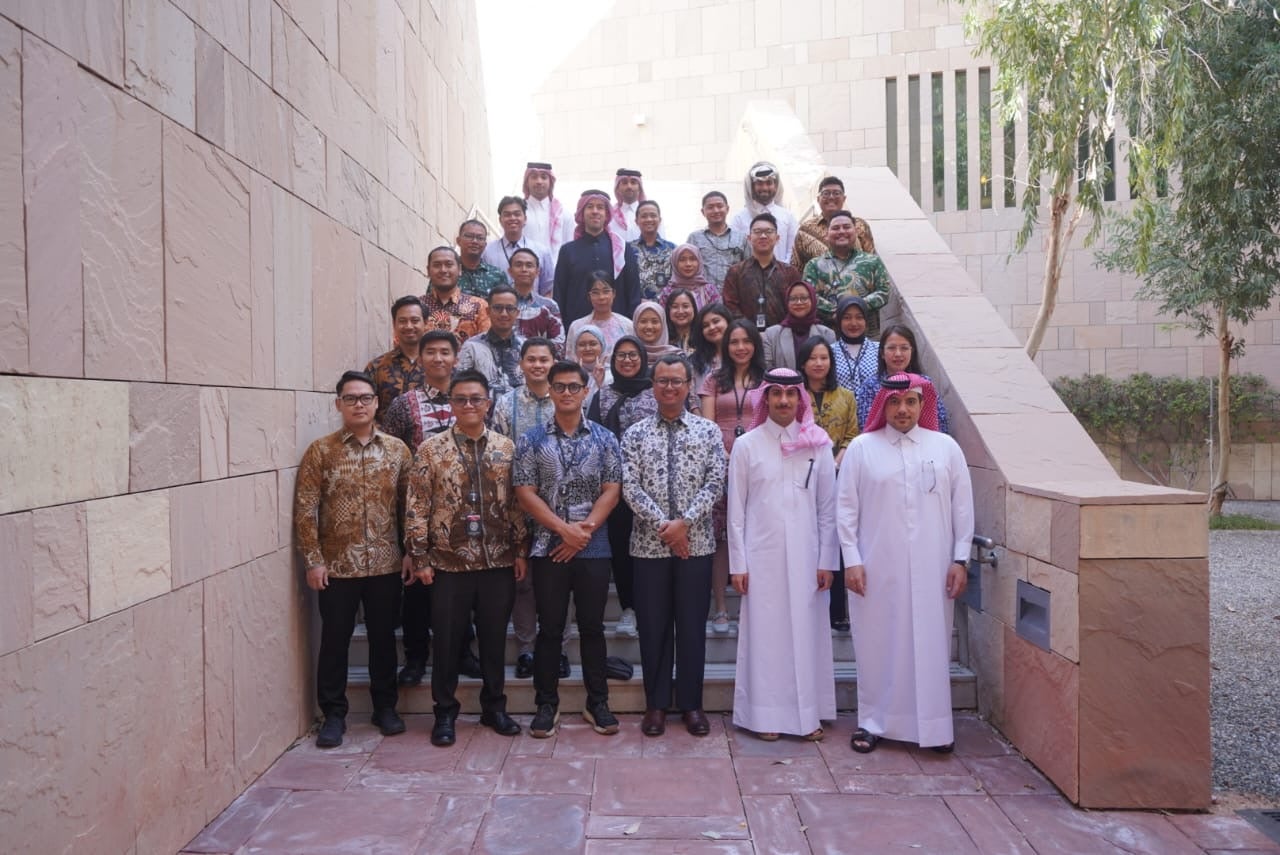 A diverse group of individuals posing on a staircase.