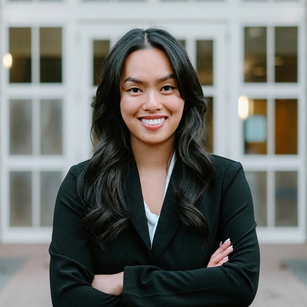Nhu Phung in business attire smiling