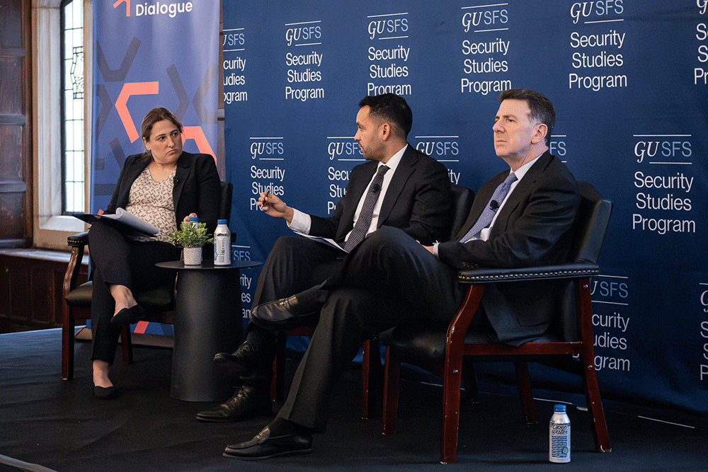 Two men and a woman speak on a panel