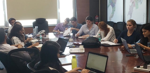 People sitting around a board room table.