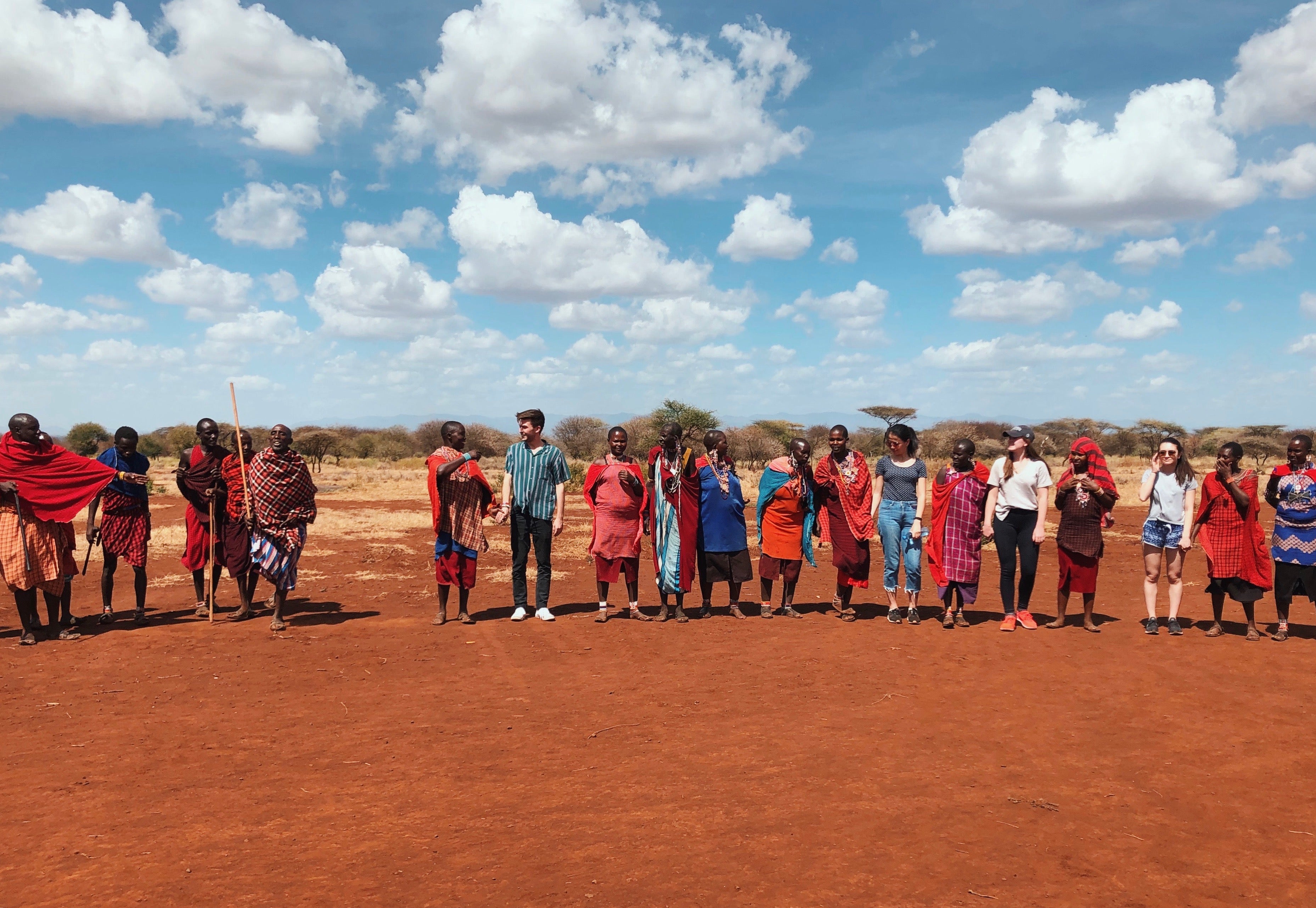 Large group of people posing outside.