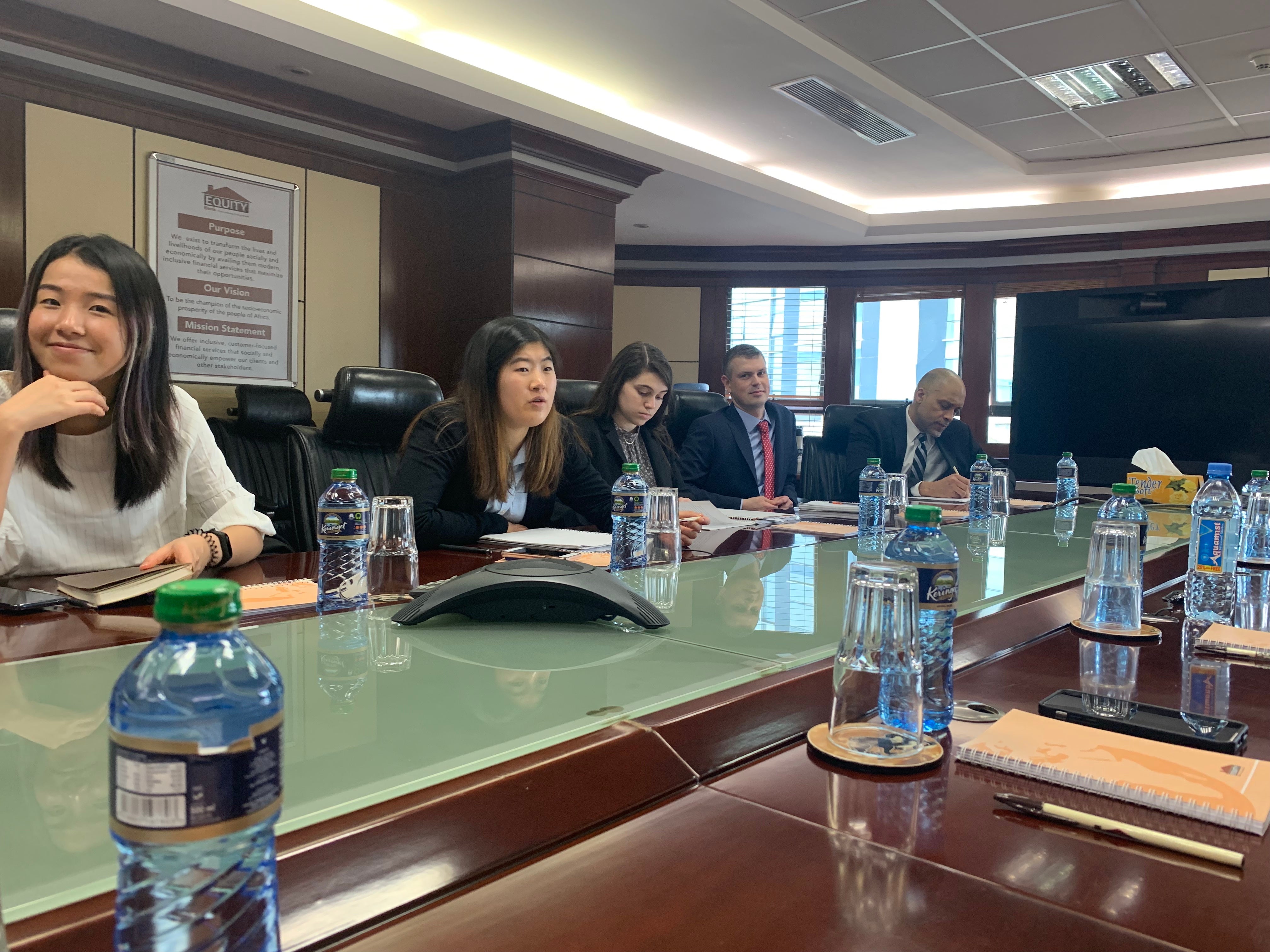 People sitting around a board room table.